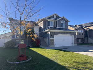 View of front of home featuring a garage and a front yard