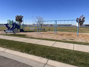 View of jungle gym with a lawn