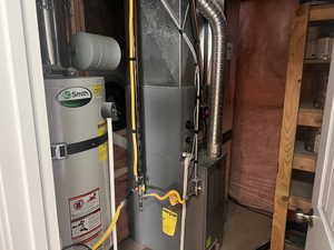 Utility room featuring gas water heater