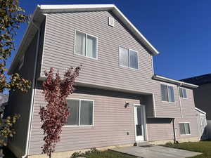 Rear view of house featuring a patio