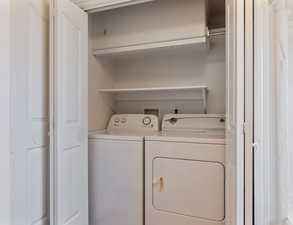 Laundry area with washing machine and dryer located in main bathroom