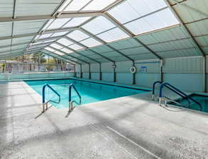 Community heated pool featuring a patio