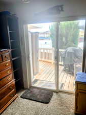 main floor second bedroom has sliding glass door to the back covered porch