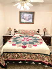 Bedroom with ceiling fan and carpet