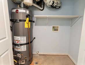 hot water heater with hook ups for a washer and dryer located in the basement