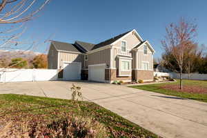 View of home's exterior with a garage, a lawn, and a mountain view