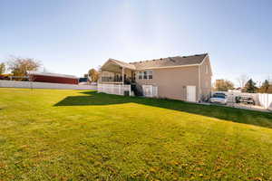 Rear view of property featuring a lawn