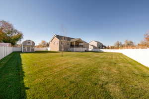 View of yard with a storage unit