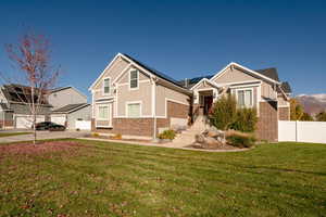 View of front of home featuring a front yard and a garage