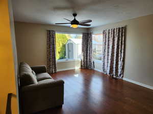 Sitting room featuring dark hardwood / wood-style flooring and ceiling fan