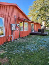 View of side of property with a lawn and a deck