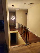 Staircase featuring hardwood / wood-style flooring