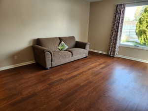 Living room with dark hardwood / wood-style floors