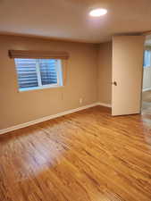 Empty room with light hardwood / wood-style flooring