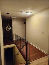 Stairway featuring hardwood / wood-style flooring