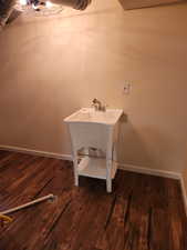 Clothes washing area featuring dark hardwood / wood-style floors