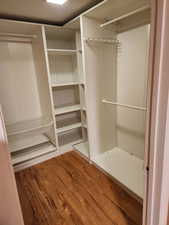 Walk in closet featuring hardwood / wood-style floors