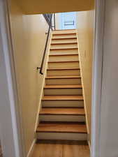 Stairs featuring wood-type flooring