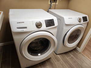 Laundry area featuring washing machine and clothes dryer