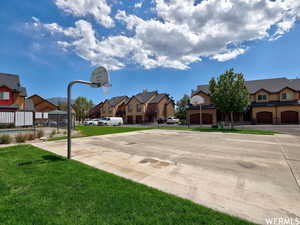 View of basketball court featuring a yard