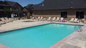 View of pool featuring a patio area with hot tub