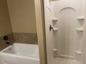 Bathroom with a bathtub and separate shower now that unit is vacant for new owners