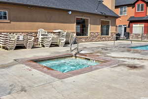 View of pool featuring a hot tub