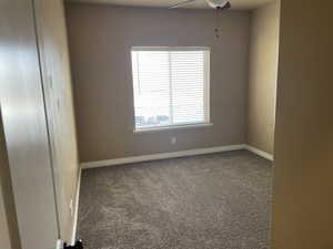 Unfurnished room featuring ceiling fan and carpet floors now that unit is vacant for new owners