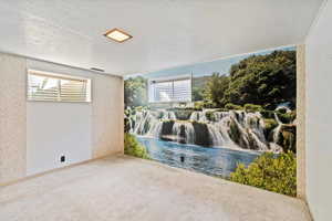 Carpeted bedroom featuring a textured ceiling