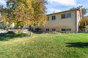 Back of house with a lawn