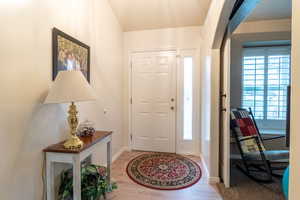 Entrance foyer with light wood-type flooring