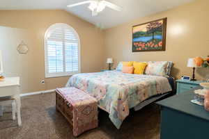 Bedroom featuring carpet, lofted ceiling, and ceiling fan