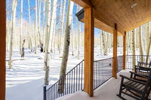 View of snow covered back of property