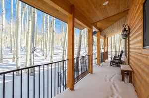 View of snow covered back of property