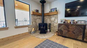 Living room featuring hardwood / wood-style floors and a wood stove