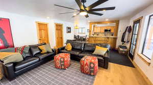 Living room with dark hardwood / wood-style flooring and ceiling fan