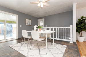 Dining space featuring ceiling fan and dark hardwood / wood-style flooring