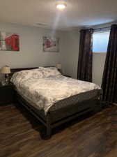 Bedroom featuring a textured ceiling and dark wood-type flooring