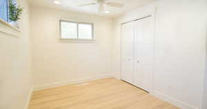 Unfurnished bedroom featuring a closet, ceiling fan, and light hardwood / wood-style flooring