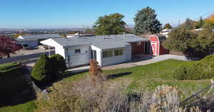 Exterior space featuring a shed and a lawn