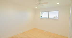 Unfurnished room with hardwood / wood-style flooring and ceiling fan