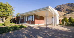 View of front of house featuring a mountain view and covered porch