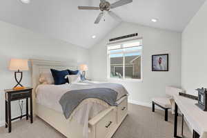 Bedroom with lofted ceiling, light carpet, and ceiling fan