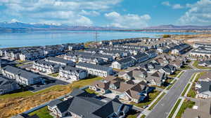 Birds eye view of property with a water and mountain view