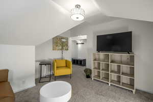 Sitting room with carpet and lofted ceiling