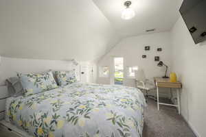 Carpeted bedroom with lofted ceiling