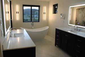 Bathroom featuring a bath and vanity