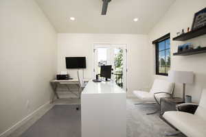 Office featuring carpet flooring and vaulted ceiling