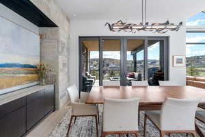 Dining area featuring light hardwood / wood-style floors, a chandelier, and a mountain view