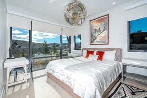 Bedroom featuring light hardwood / wood-style flooring and an inviting chandelier